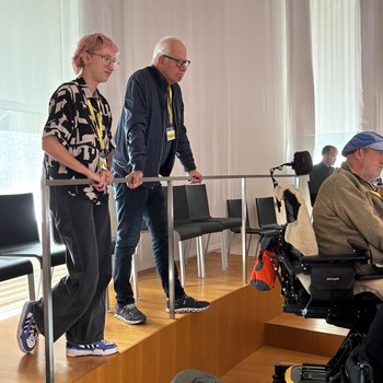 Zwei stehende Personen auf der Zuschauertribüne im Kantonsratssaal